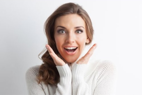 Face of a smiling woman, and surprised expression of the face.