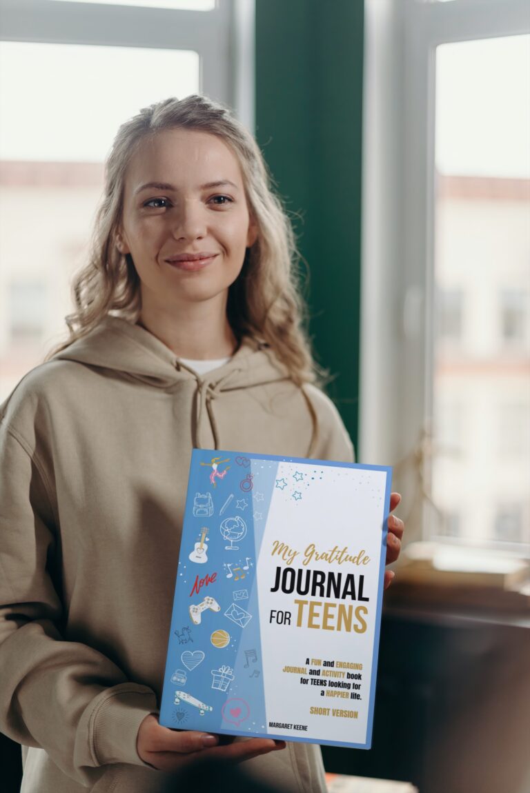 A GIRL standing on her feet is also holding her copy of our Gratitude Journal for Teens